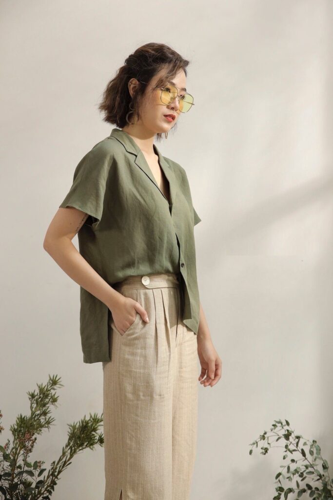 A lady wearing an olive-colored top and beige pants