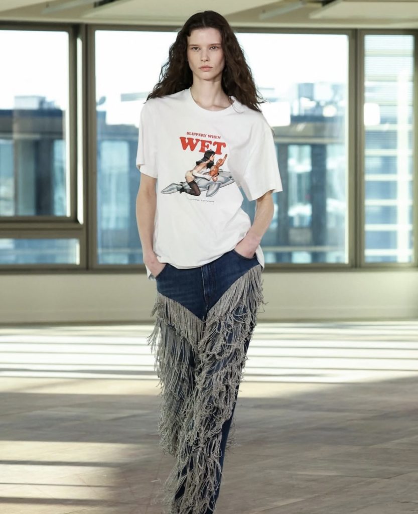 A beautiful white lady wearing a Stella McCartney denim trousers