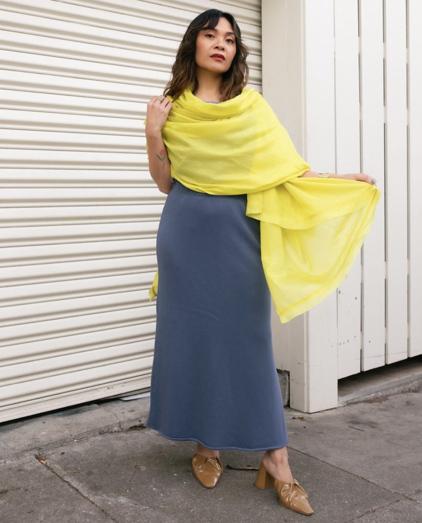 A beautiful white lady wearing an outfit from a fashion brand called Eileenfisher