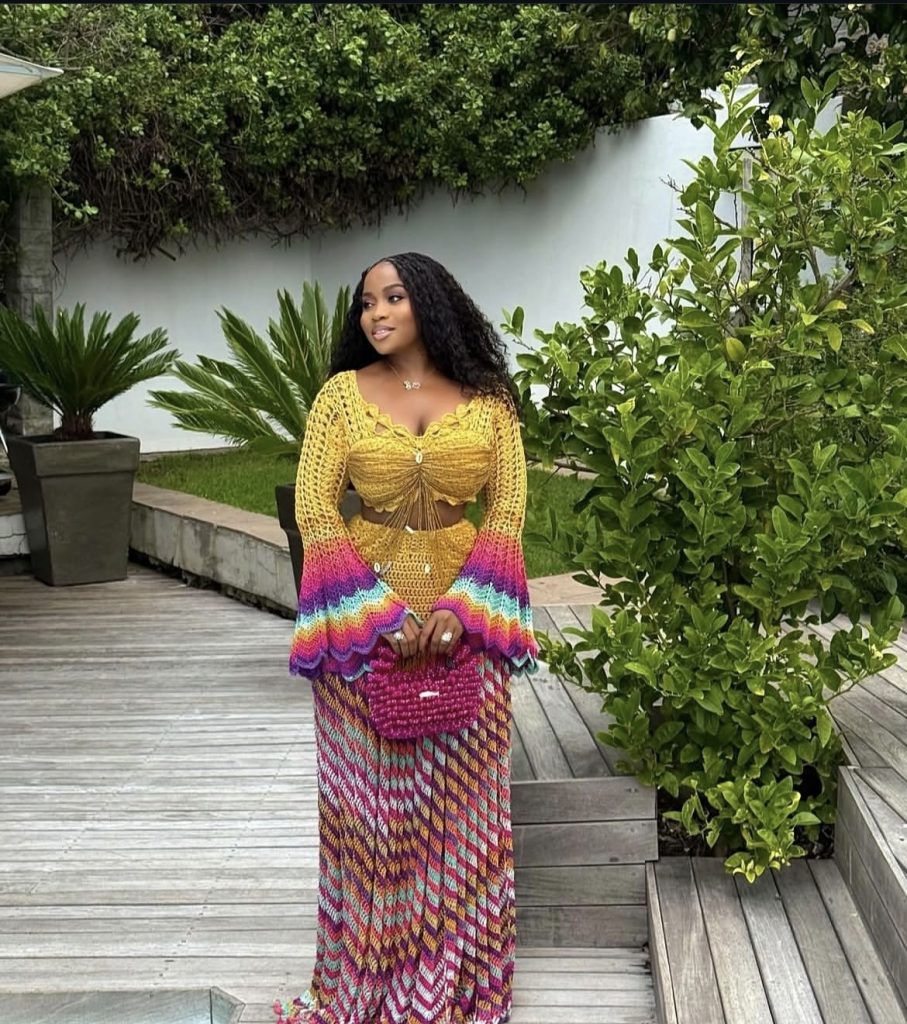 A beautiful lady wearing very colorful and pretty crochet outfit