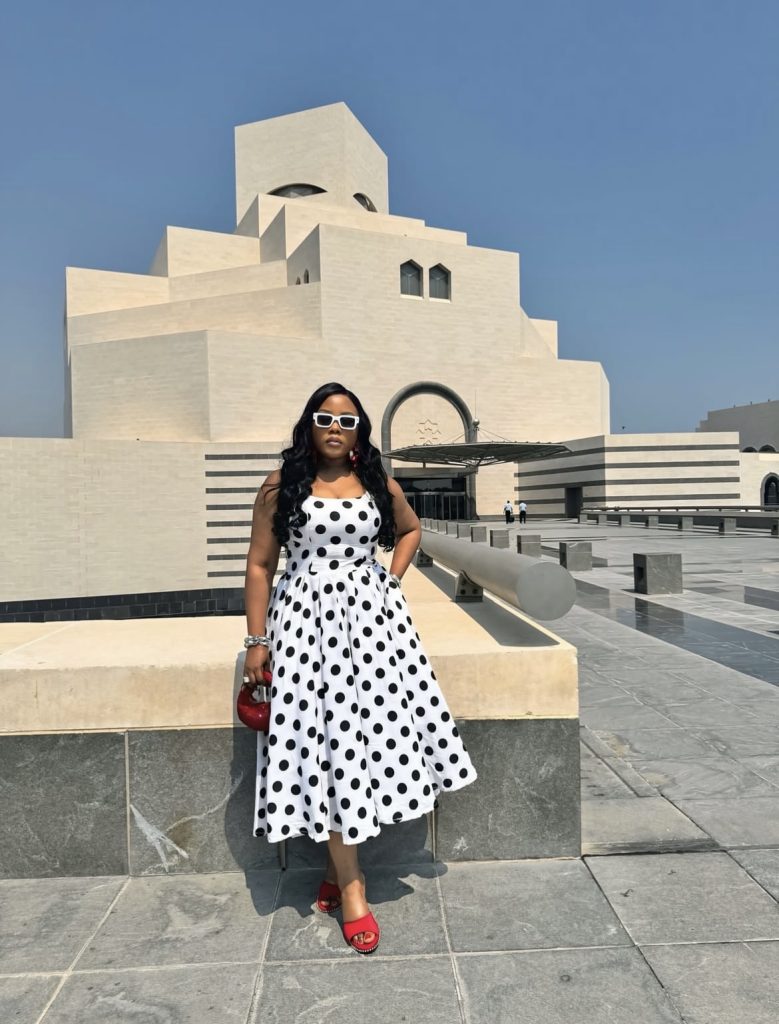 A beautiful black lady looking stylish with her matching shoes and bag