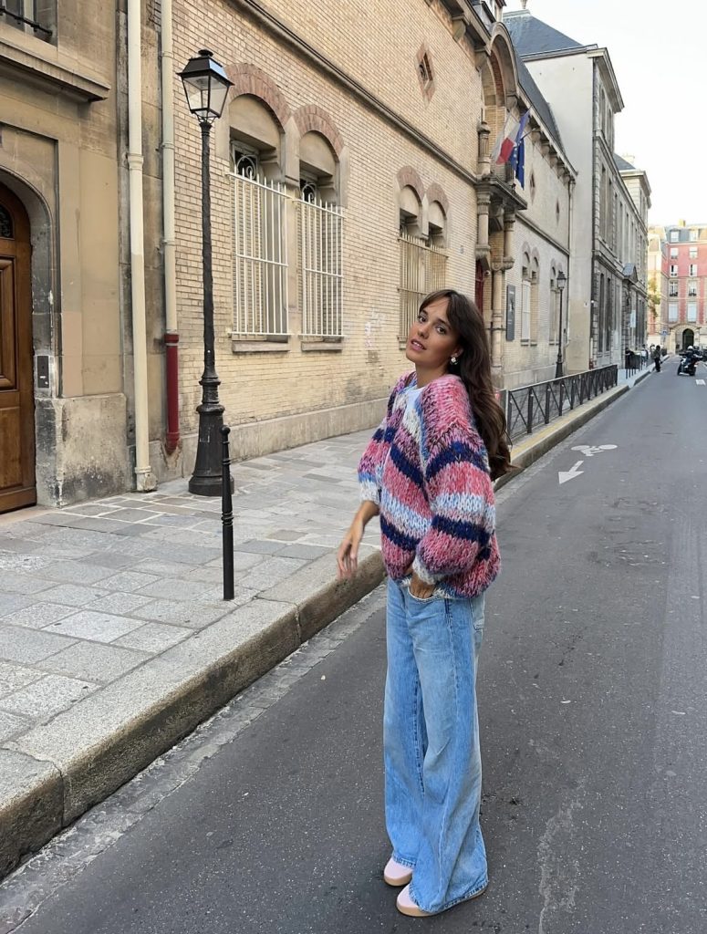A beautiful lady wearing a pink mixed colored knitwear