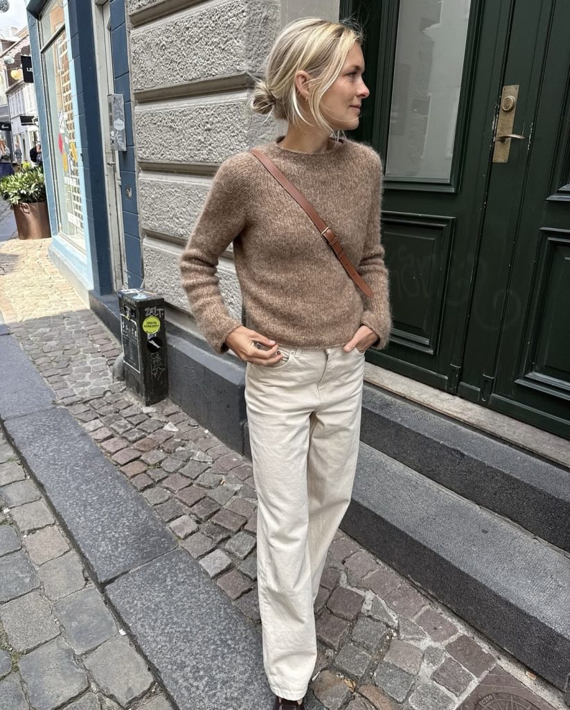 A beautiful lady wearing a brown knitwear