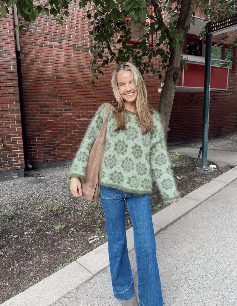 A beautiful lady wearing a green knitwear