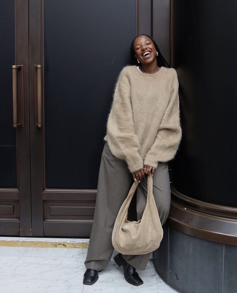 A beautiful lady wearing a brown sweater