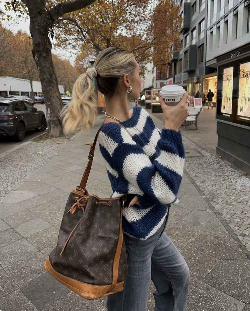 A lady wearing a light weight sweater