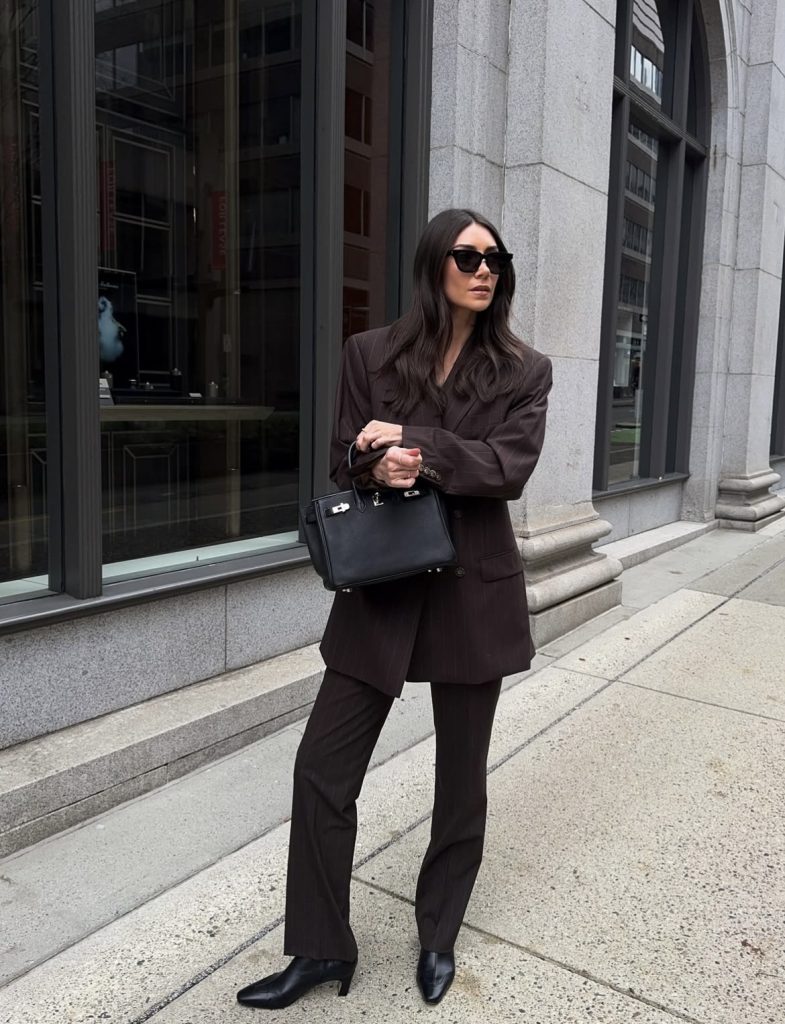 A beautiful woman wearing a vintage power shoulder blazer with a modern mix.