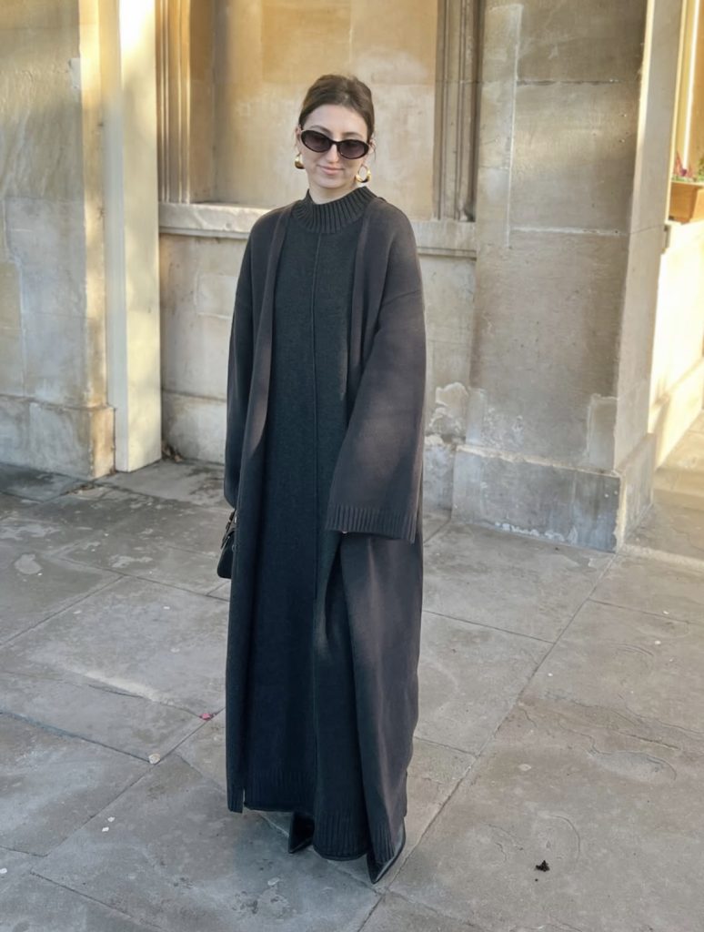 A beautiful woman wearing a fur and leather vintage and modern mix outfit