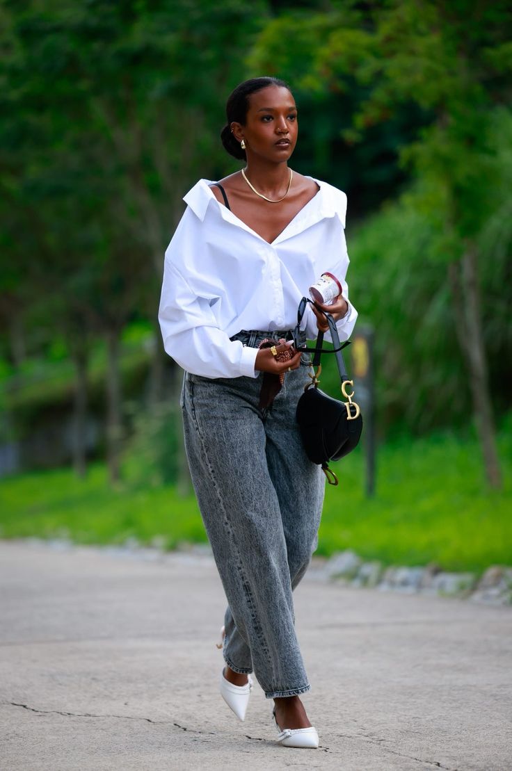 A beautiful black woman styling a white shirt