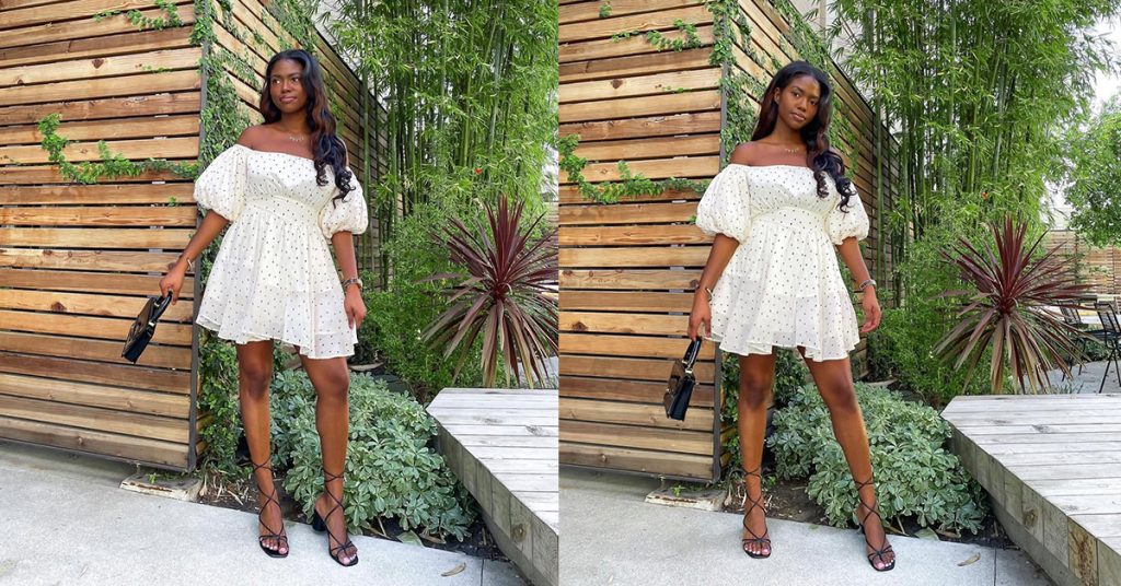 A beautiful black lady weariung a puffed sleeves white dress